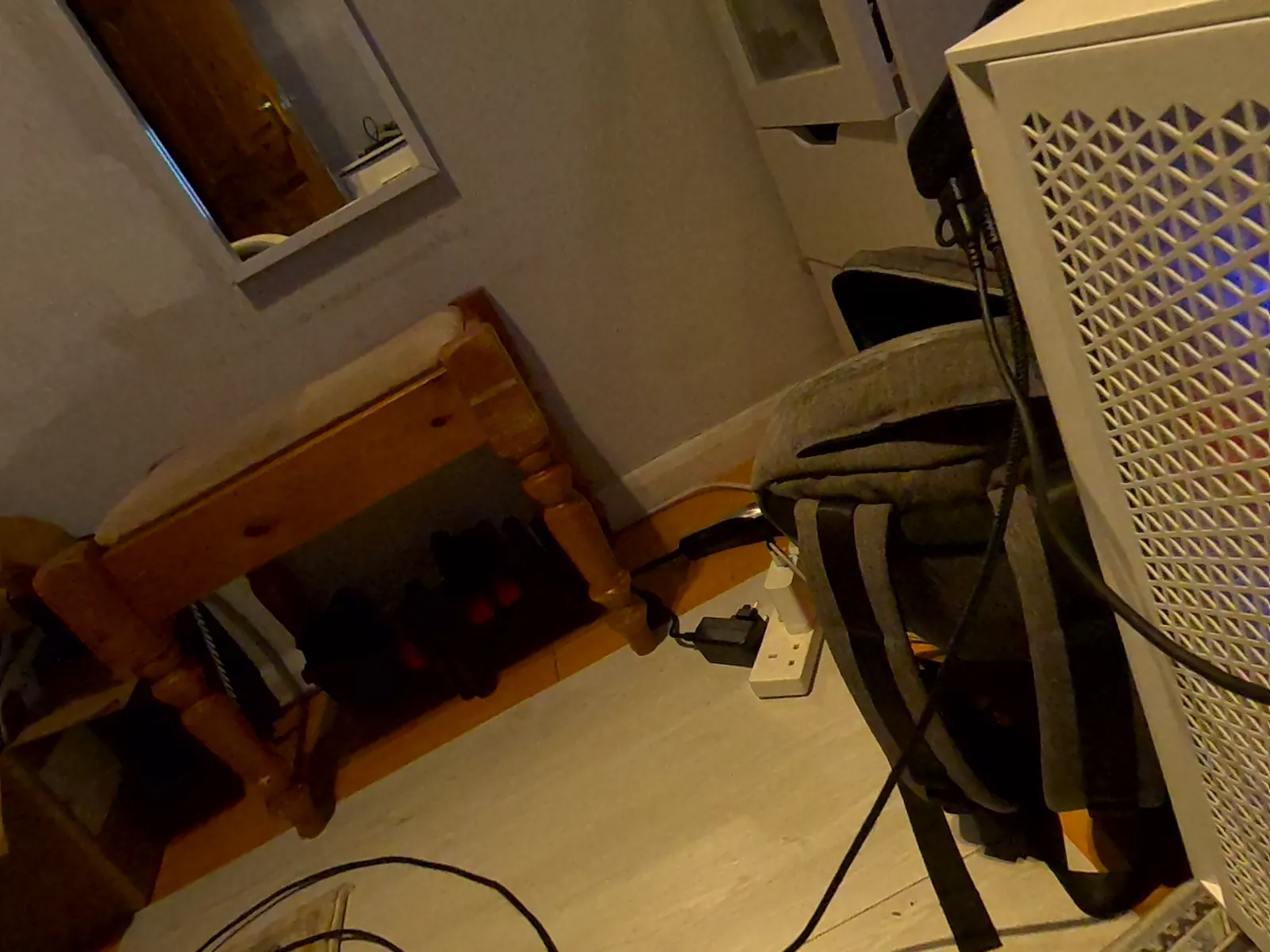 Wooden bench, radiator and cables on a carpet, as seen by the headset camera and as rendered from the splat (Headset camera)