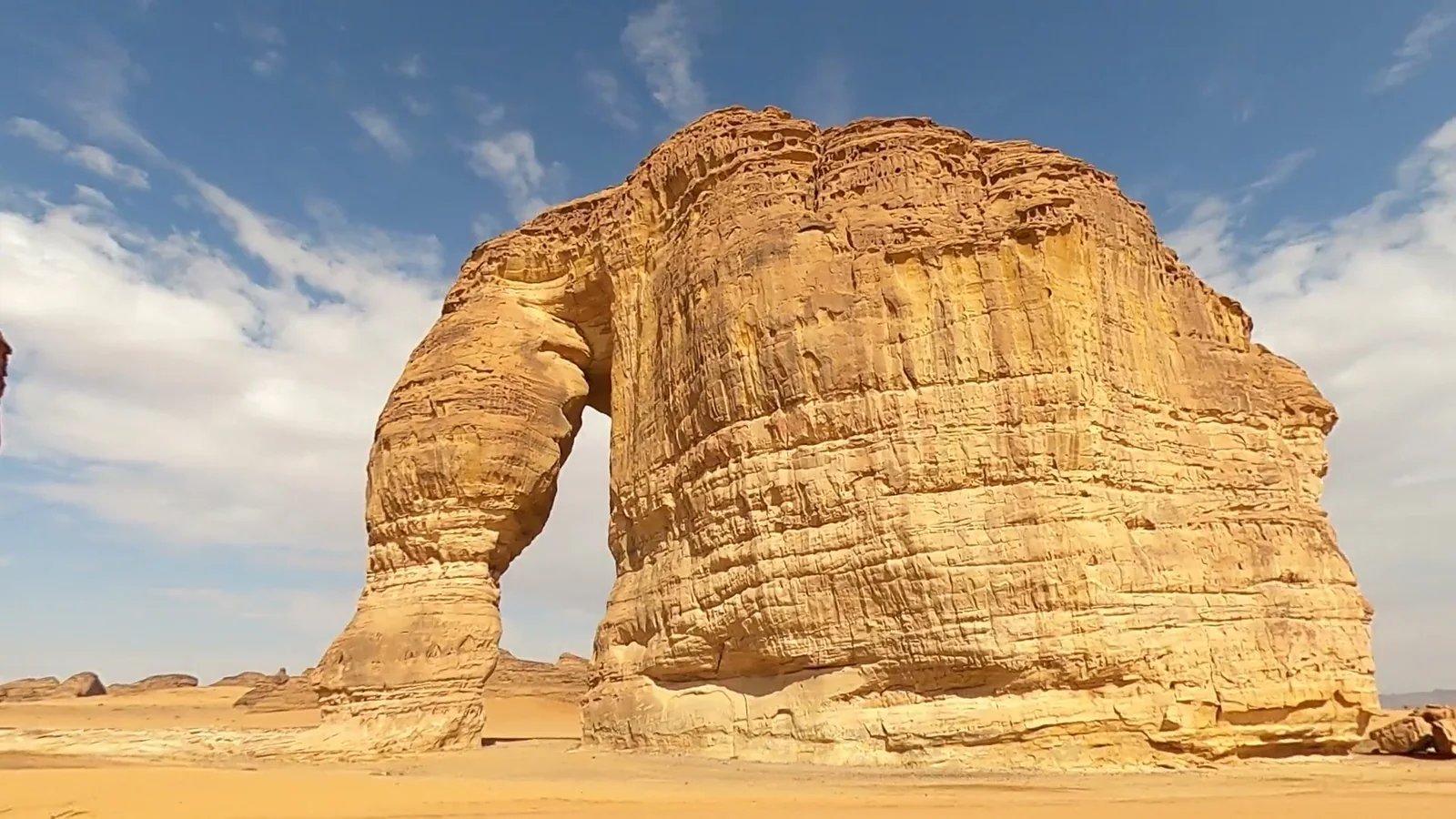 Photo of Elephant Rock near AlUla today, with a car beside it